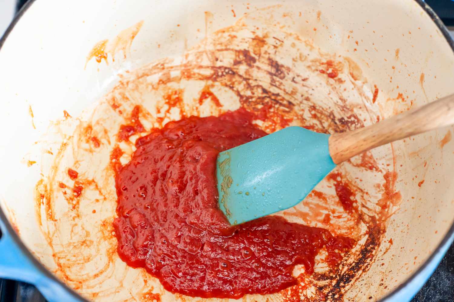 Spatula Used to Stir Tomato Paste in a Dutch Oven for Vegan Cincinnati Chili Recipe