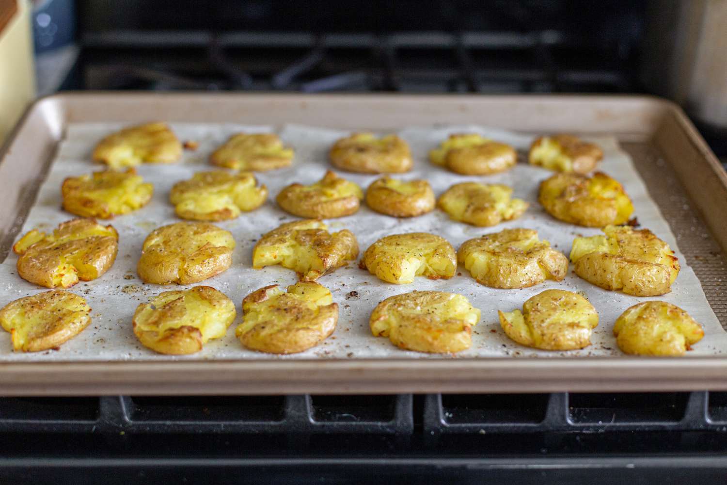 Smashed potatoes on a baking sheet to make cream cheese and smoked salmon crispy potatoes.