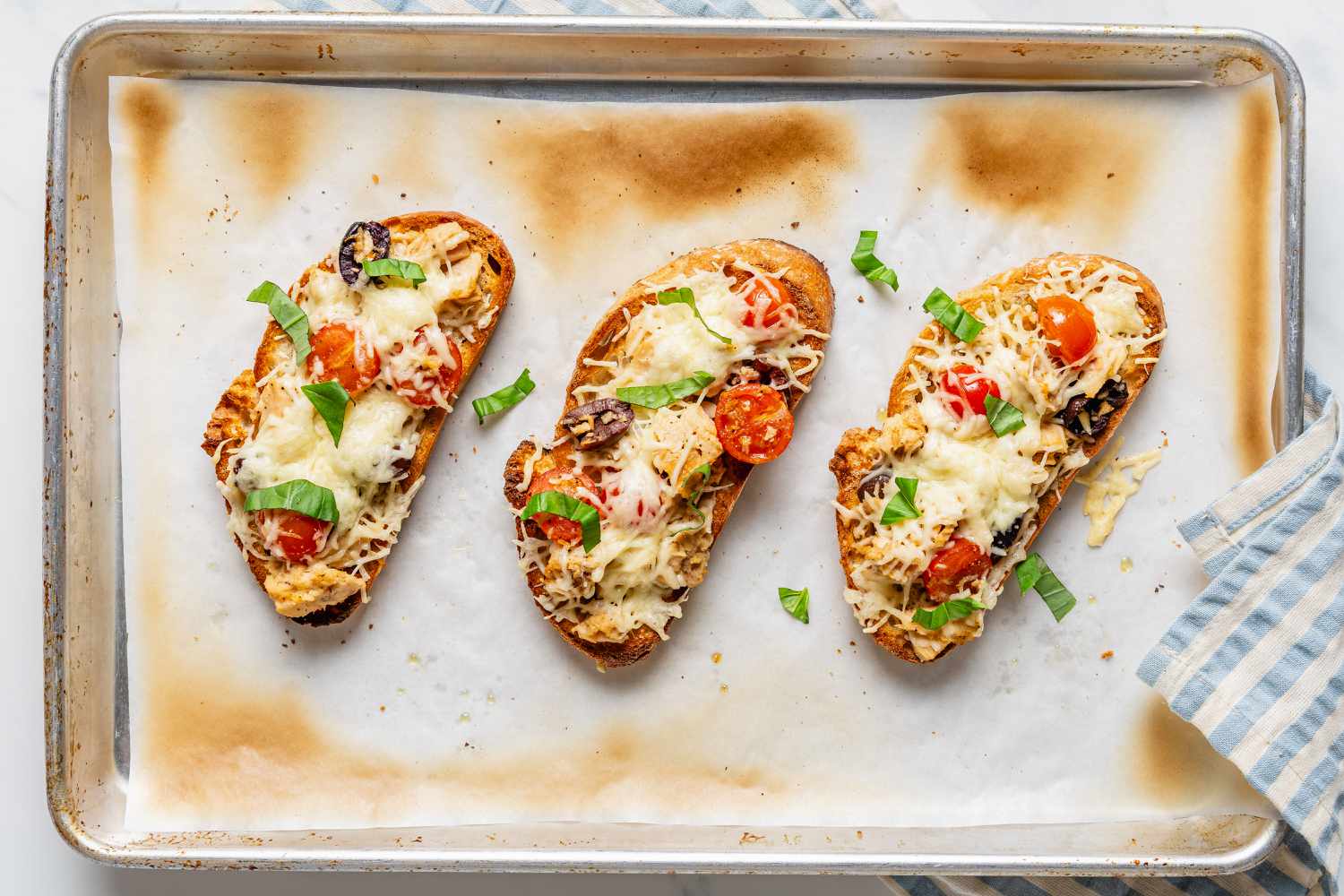 Tuna Niçoise Melts - 3 of them on a parchment lined sheet-pan