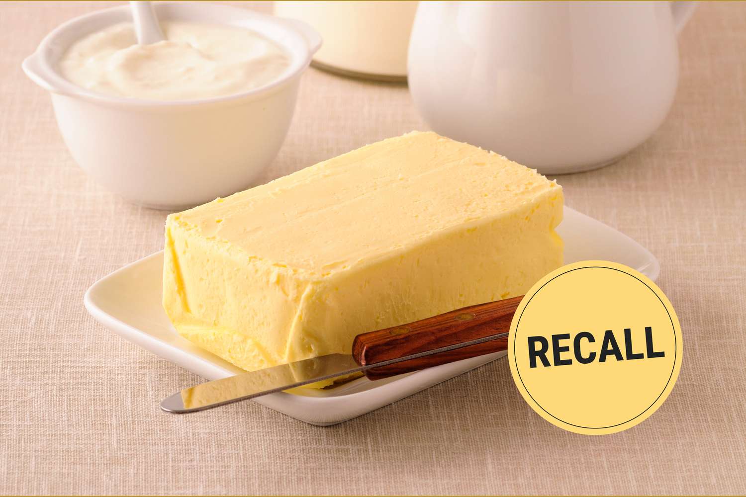 Stick of butter on a plate with a knife, "Recall" label placed over the image.