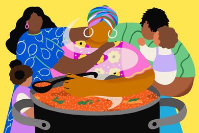 People standing around a pot of jollof rice