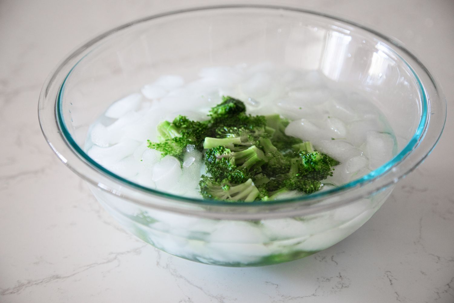 Boiled Broccoli Cooling in the Bowl of Ice Water for How to Blanch Broccoli