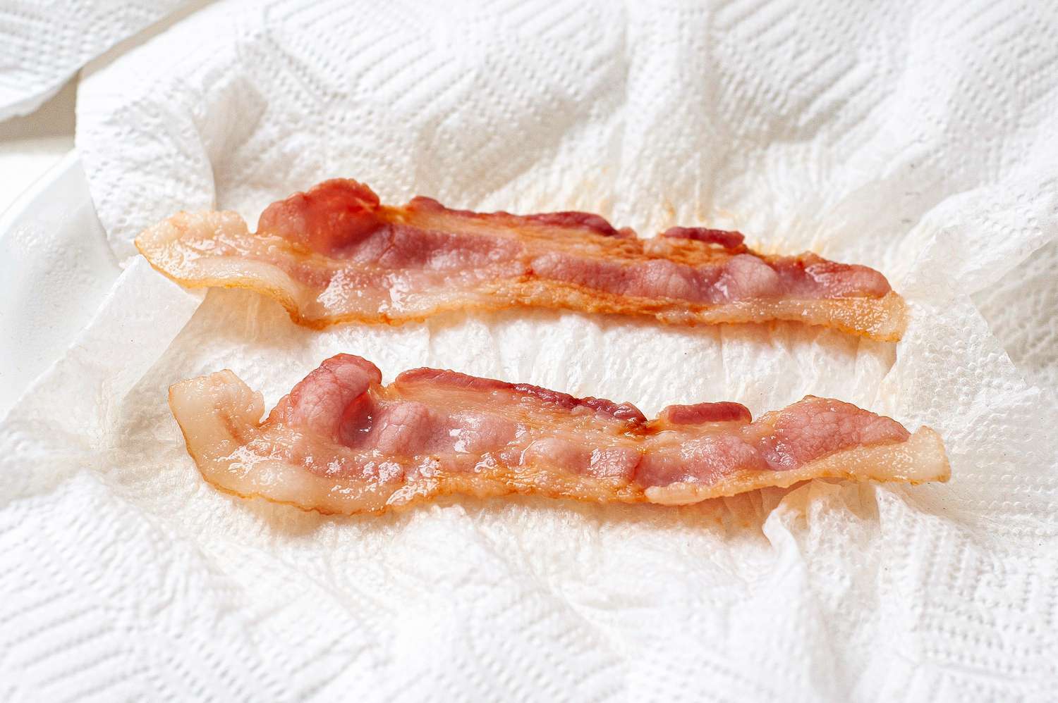 Microwave Bacon Partially Cooked with the Paper Towels Absorbing Some of the Bacon Fat 