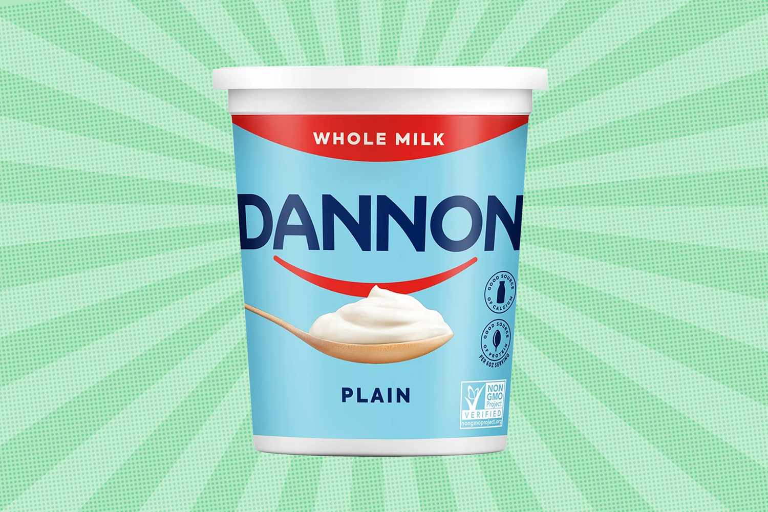Tub of Dannon plain whole milk yogurt with a spoon on the front against a green pattern background