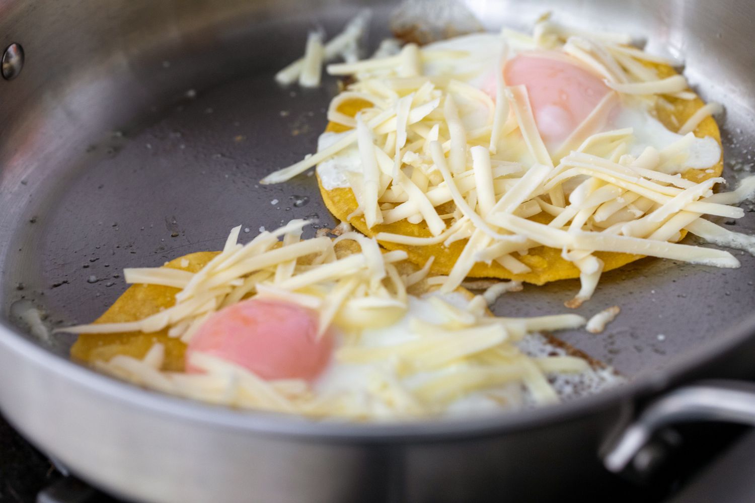 Tortilla, cheese, and eggs for fried egg taco