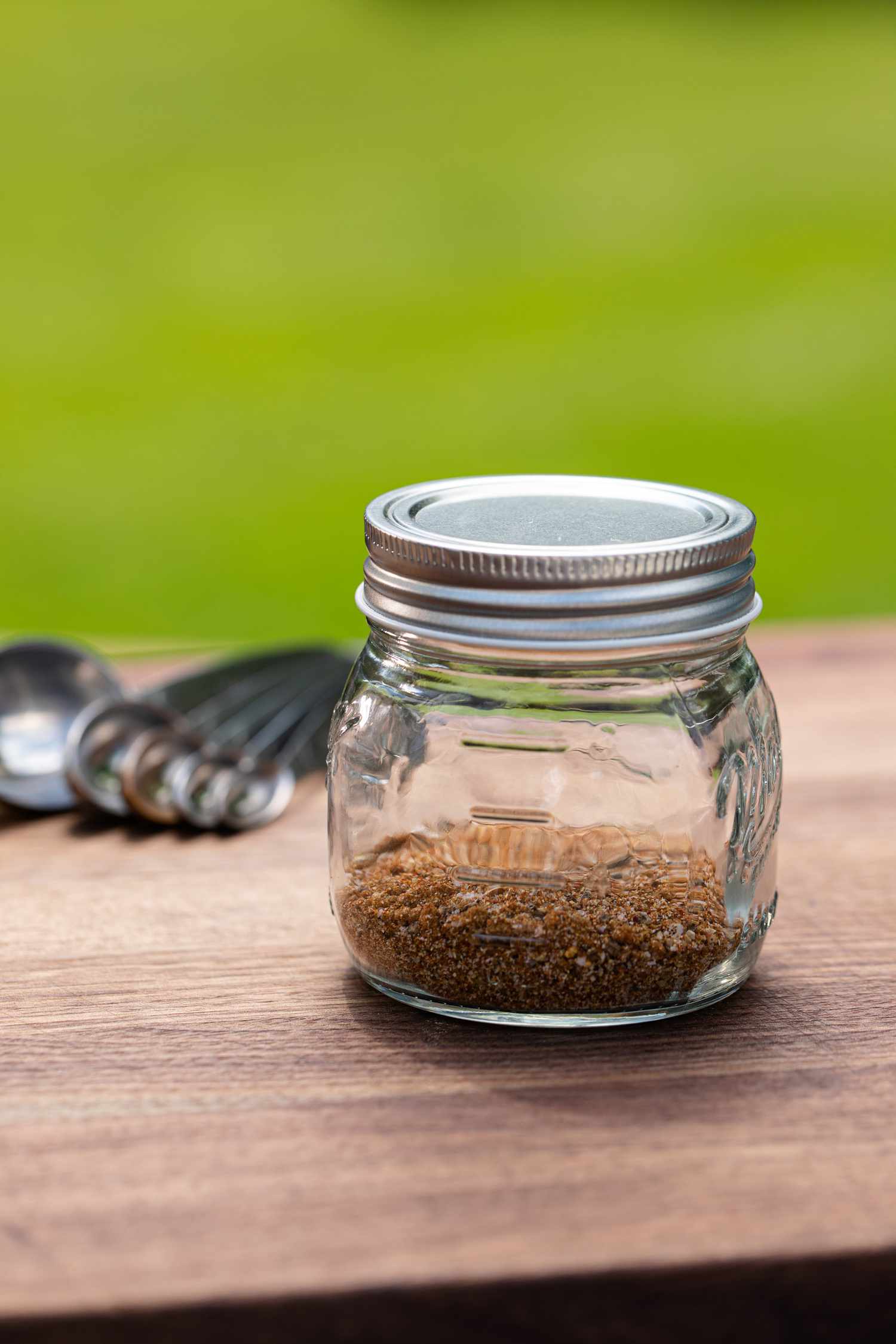 Hamburger Seasoning outside in a glass jar.