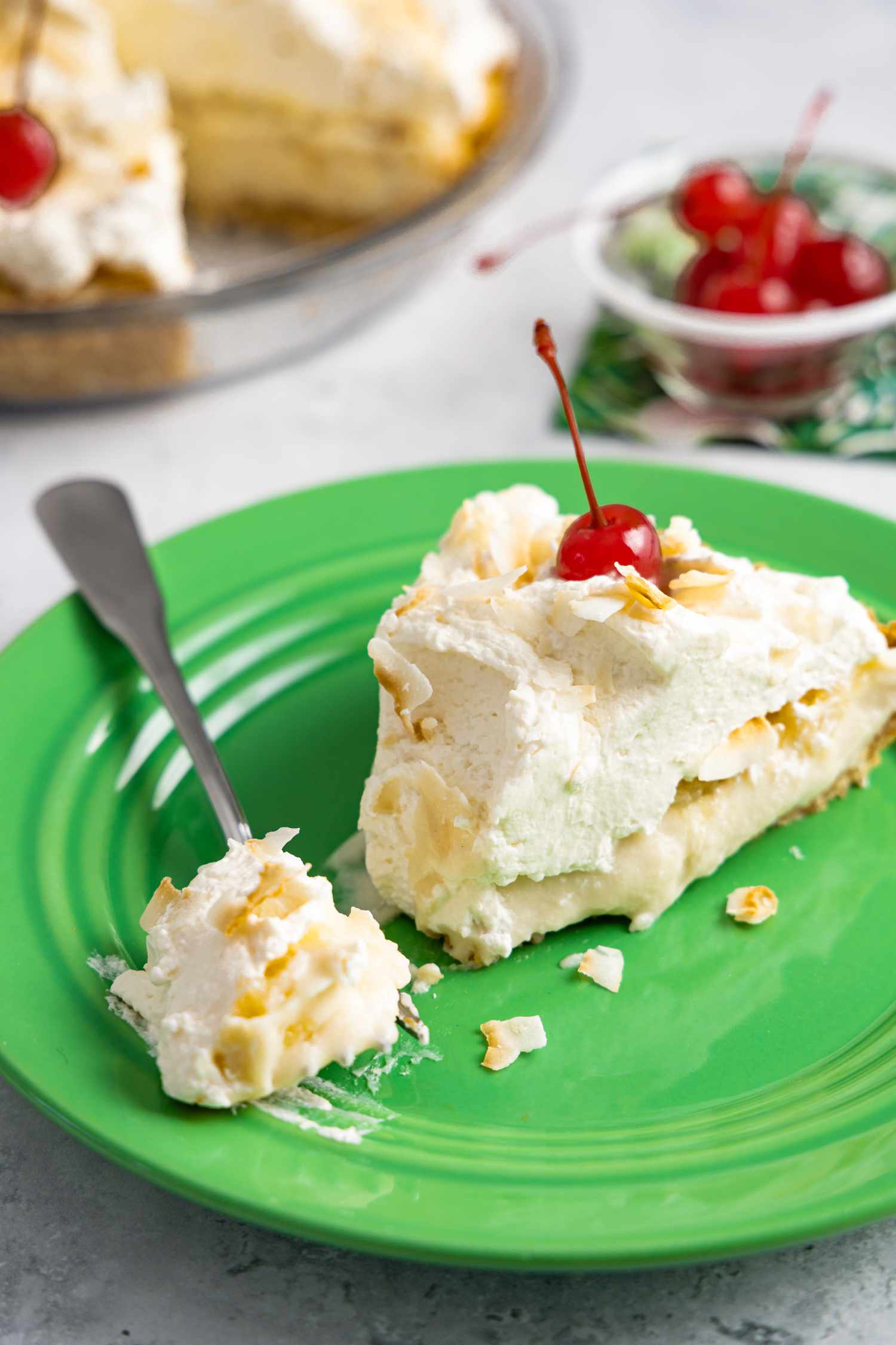 Slice of Piña Colada Pie on a Plate with Some on a Fork