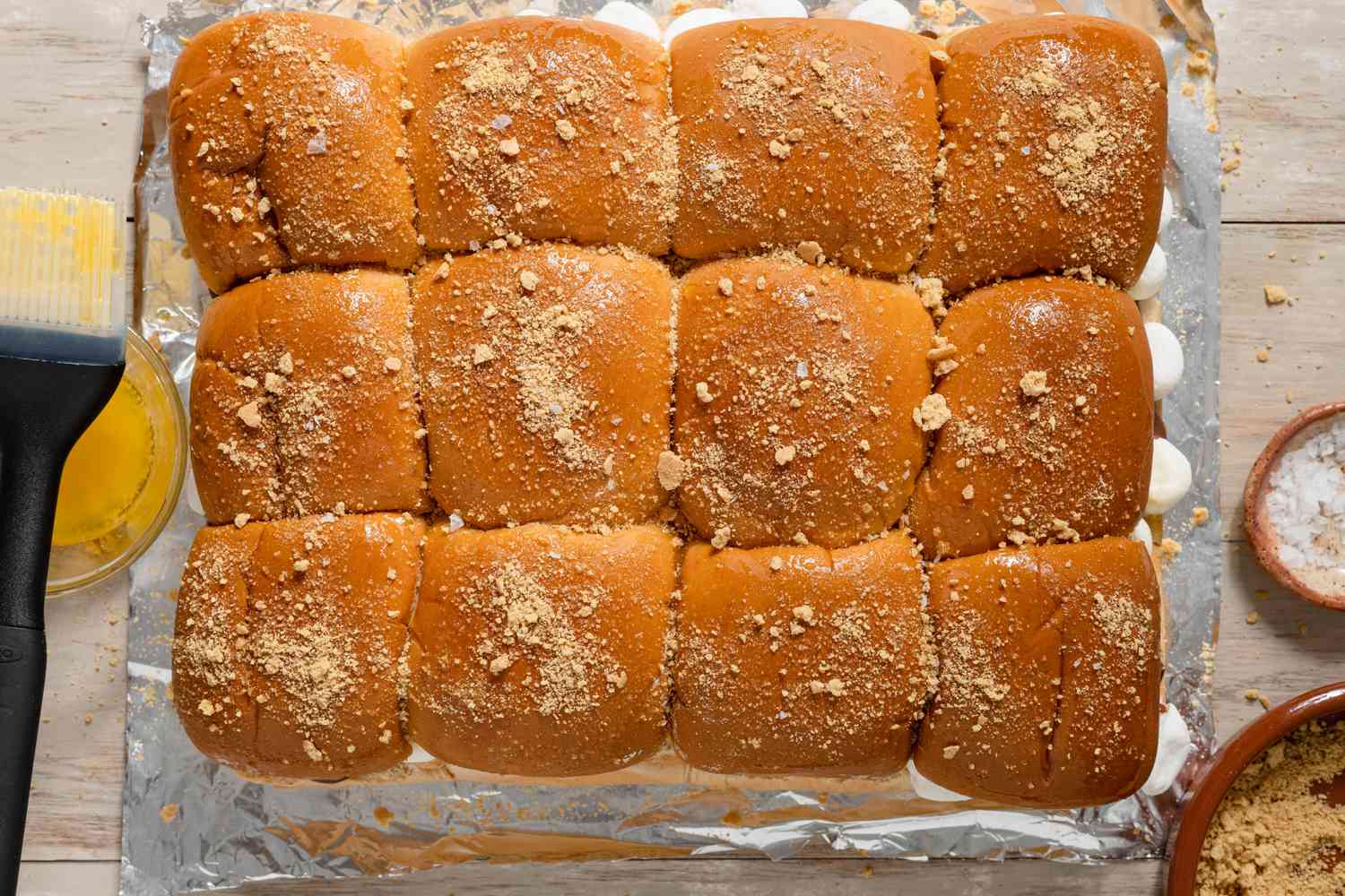 Grilled Smores Sliders Topped With Graham Cracker Crumb on a Piece of Aluminum Foil on the Counter 