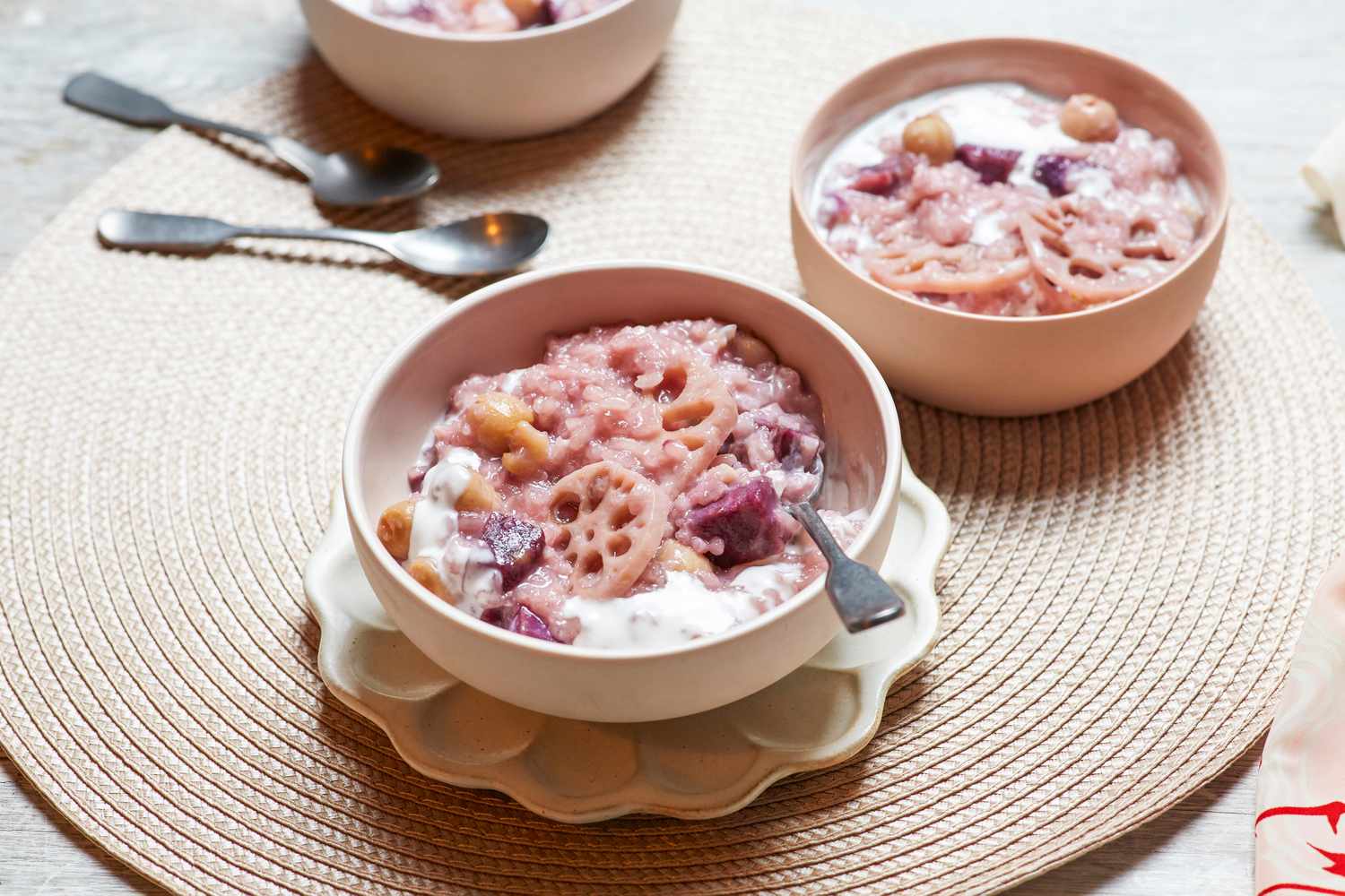 Two bowls of Vietnamese coconut rice pudding served with spoons.