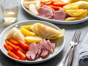 New England Boiled Dinner on platter and a plate at a dinner table