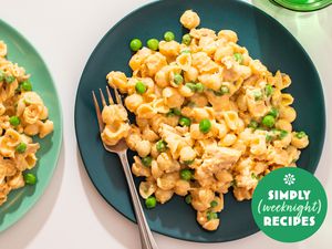 Plate of creamy pasta with peas and a fork, Simply Weeknight Recipes logo in the corner