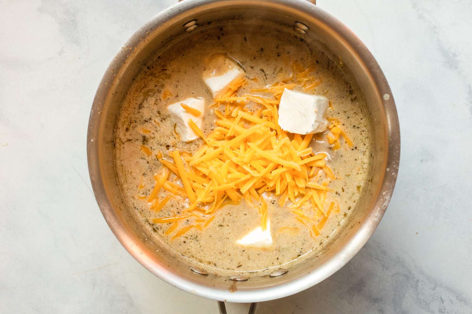 Add the cheeses to the soup.