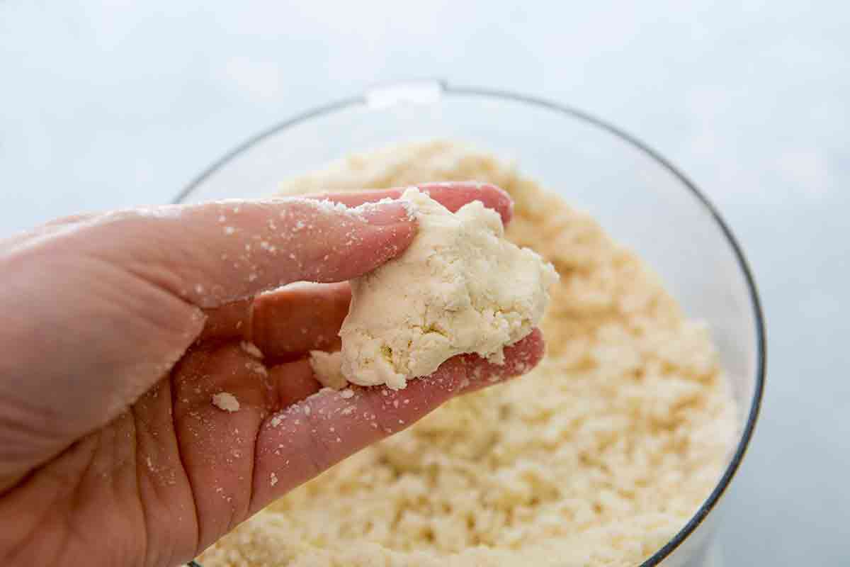 press pie dough to see if it holds together
