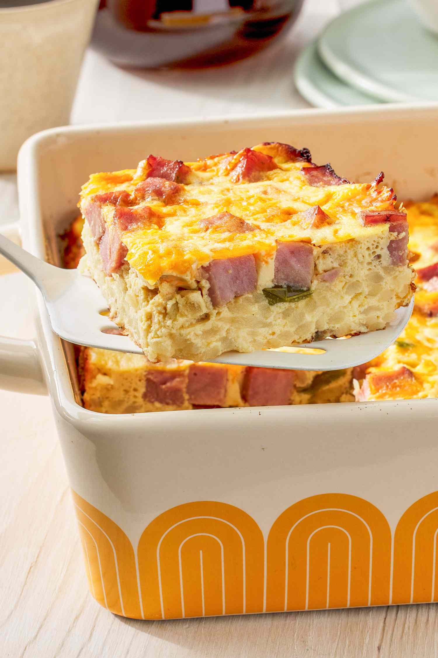 Slice of Denver omelette hashbrown casserole lifted from a casserole dish