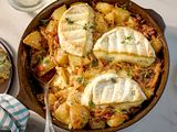 Skillet of tartiflette with melted cheese and potatoes served on a table