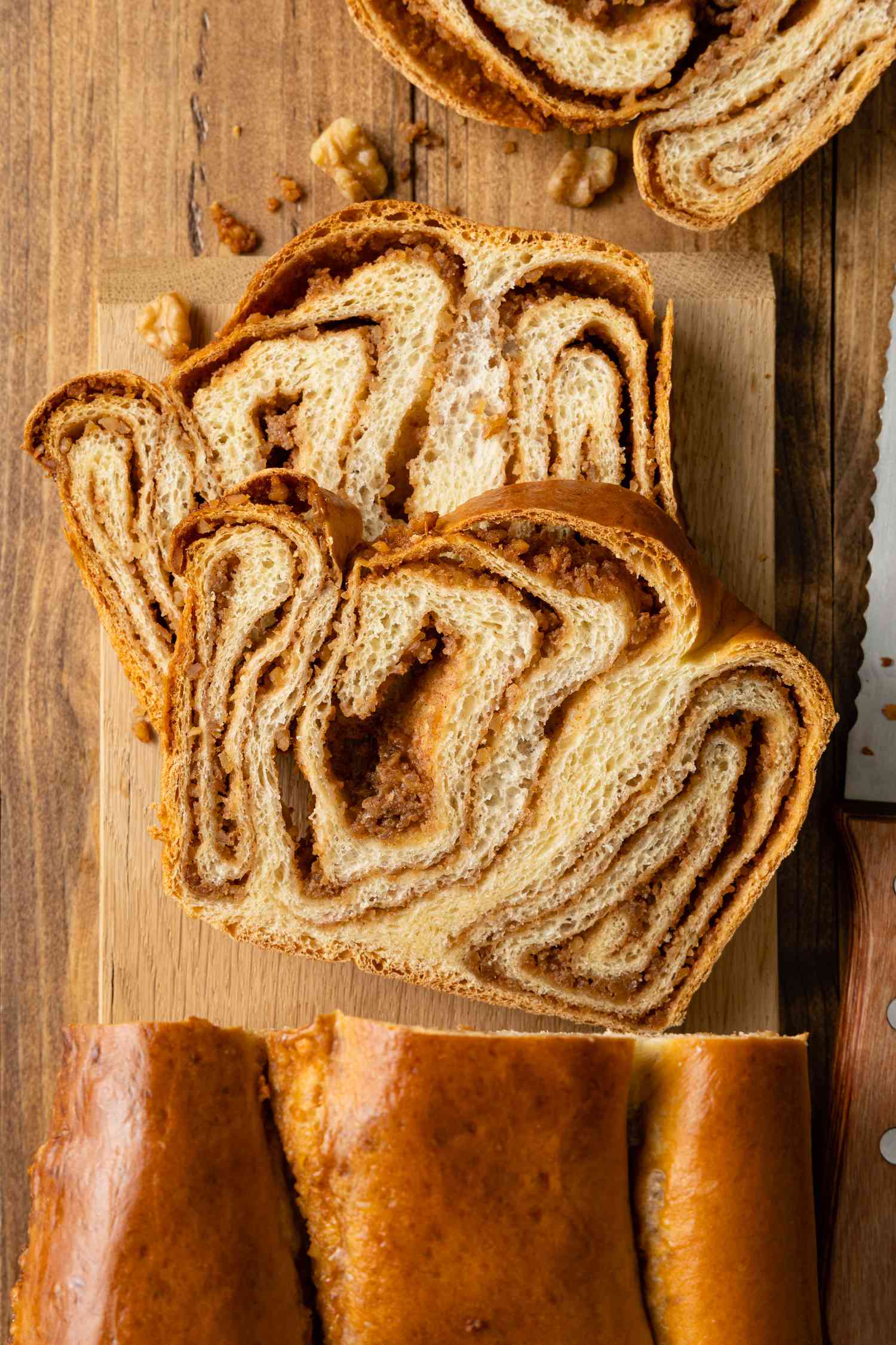 Slices of Povitica Next to a Loaf on a Cutting Board