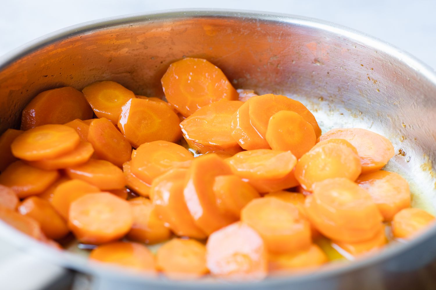 Making a cooked carrots recipe in a skillet.