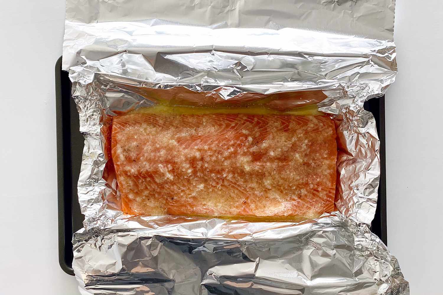 Foil Packet Baked Salmon baked and coated with melted garlic butter.