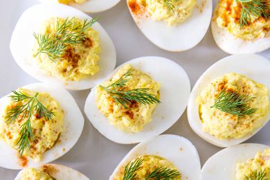 How to Make Deviled Eggs -- Close up of deviled eggs with dill and paprika