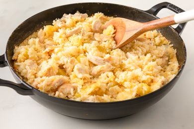Side vew of one pot chicken and rice in a cast iron pot 
