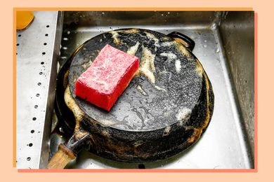 skillet in sink with sponge
