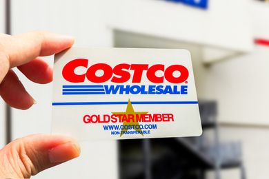 Costco membership card being held in front of a store entrance
