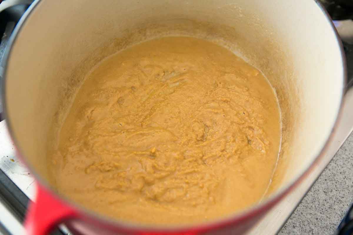 Continue cooking the roux for shrimp gumbo until it starts to thicken and turn color