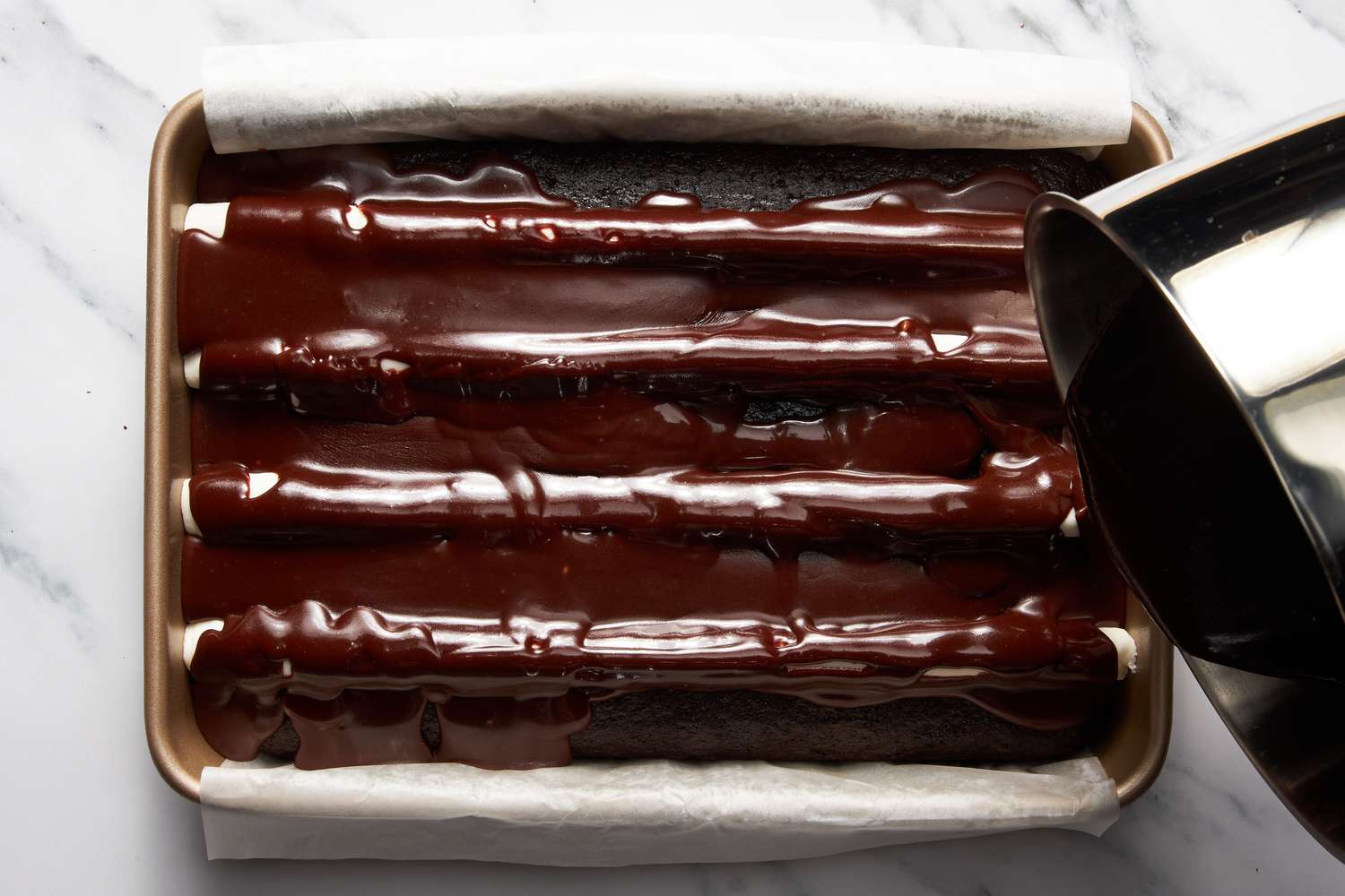 Chocolate fudge added to the cake pan with the bumpy cake