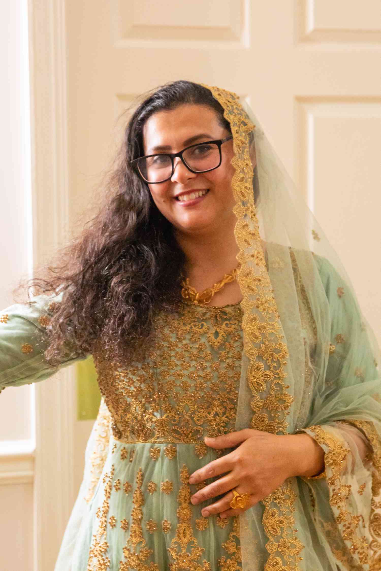 Woman smiling in a blue outfit 