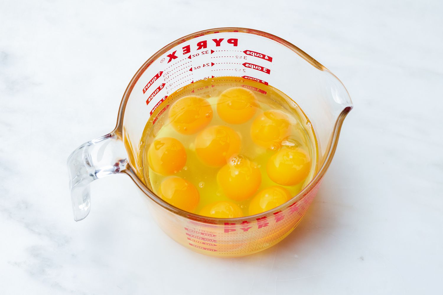 Pyrex Measuring Cup With All the Cracked Eggs