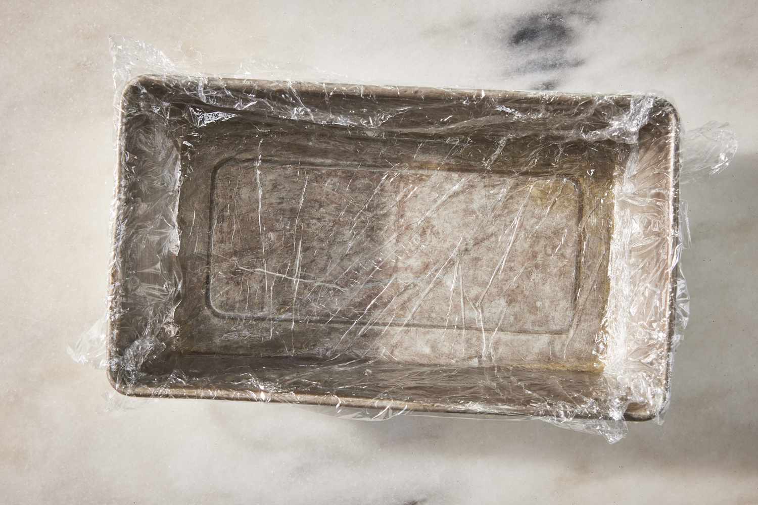 loaf pan wrapped in plastic for strawberry marlow recipe
