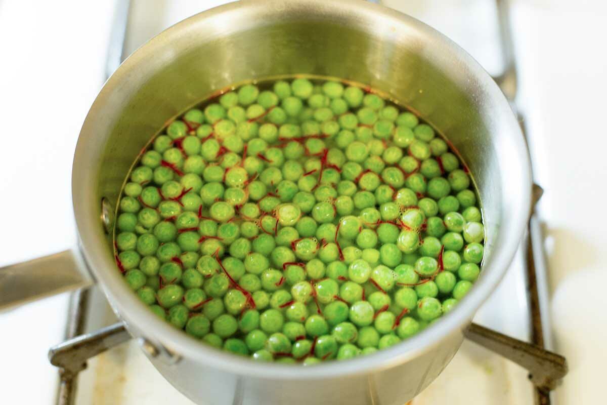 Steep the saffron with the peas in the chicken broth for making instant pot paella