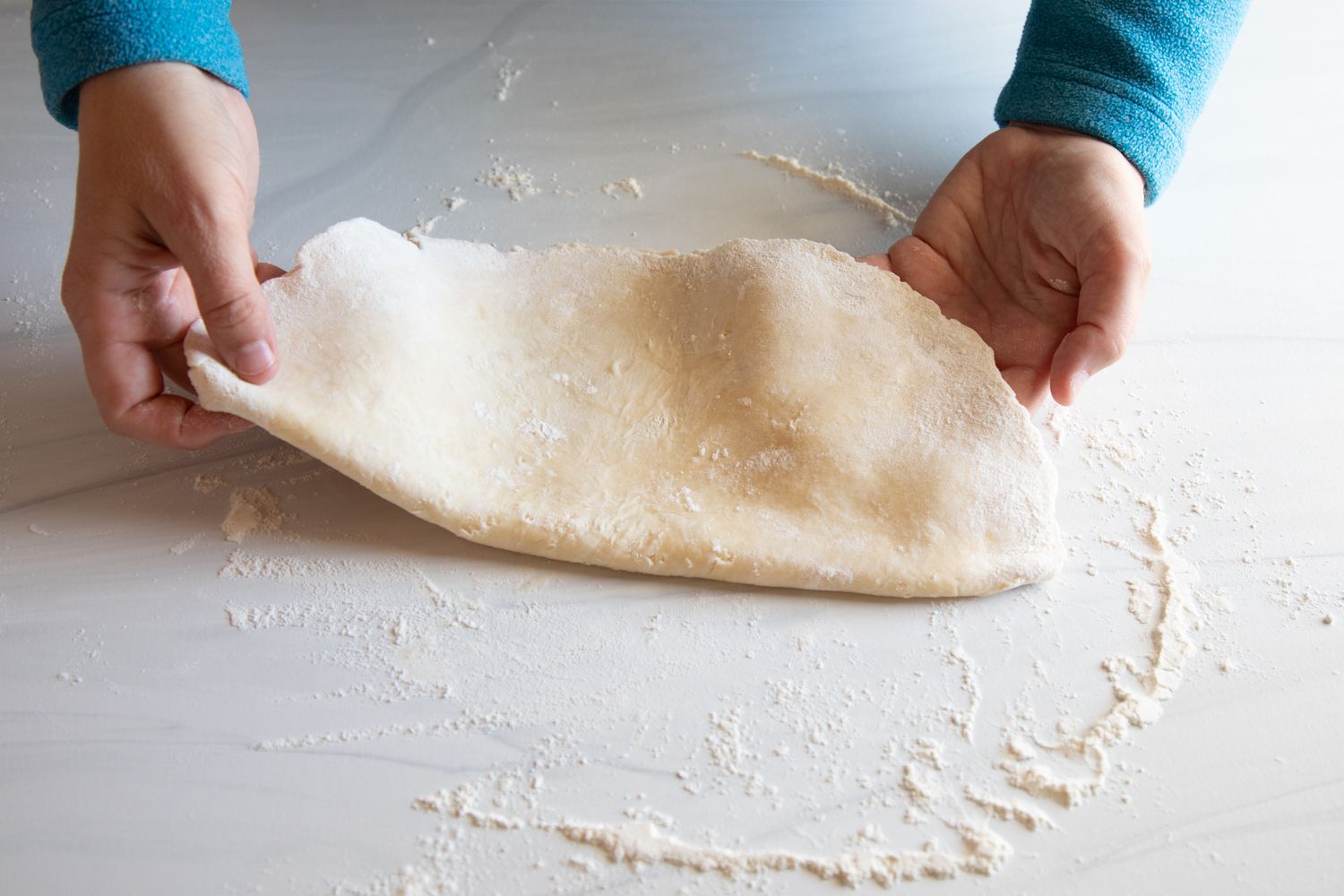 Folding rolled out pie dough to make a Dixieland Peanut Pie with Porter.