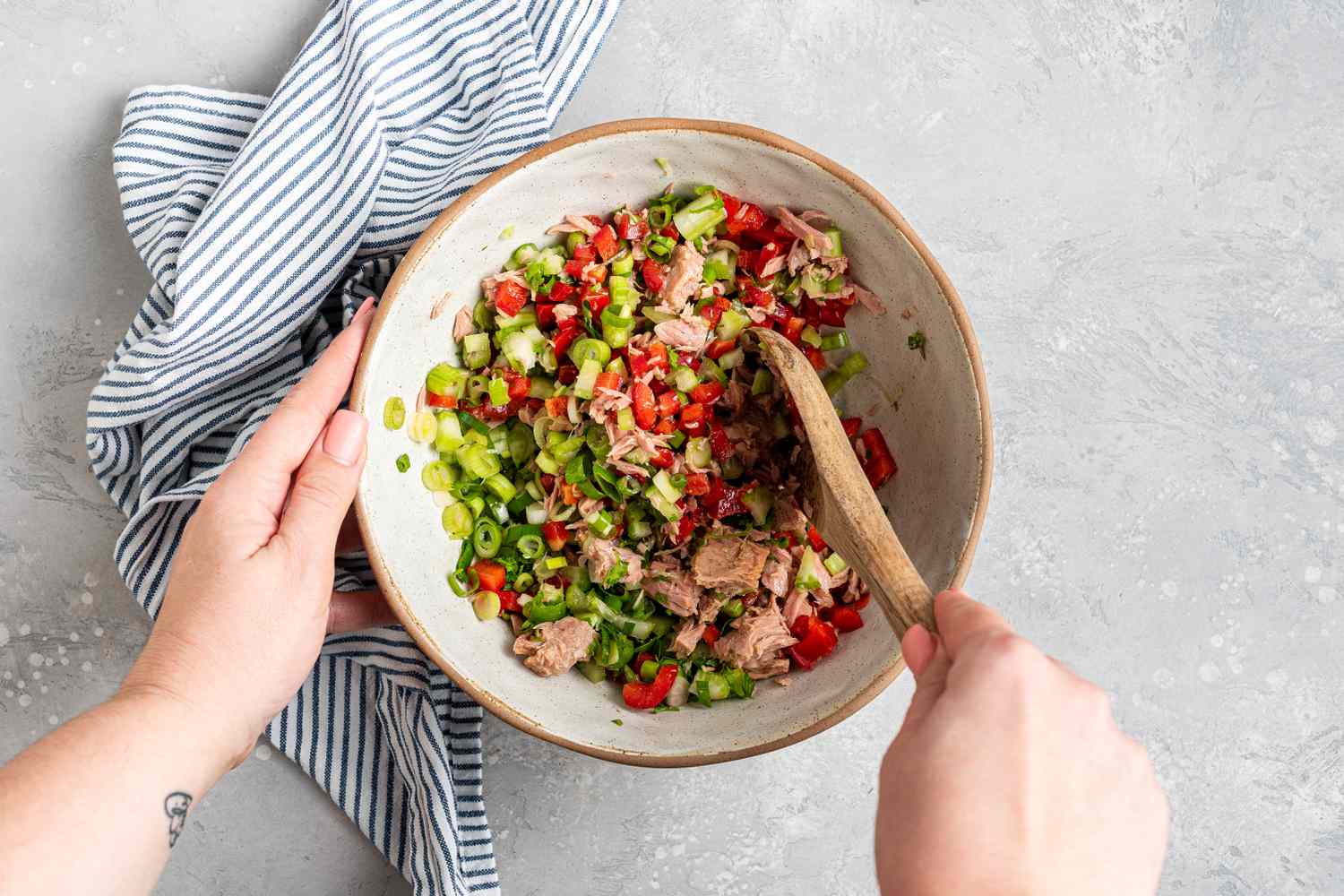 mixing tuna pasta salad ingredients