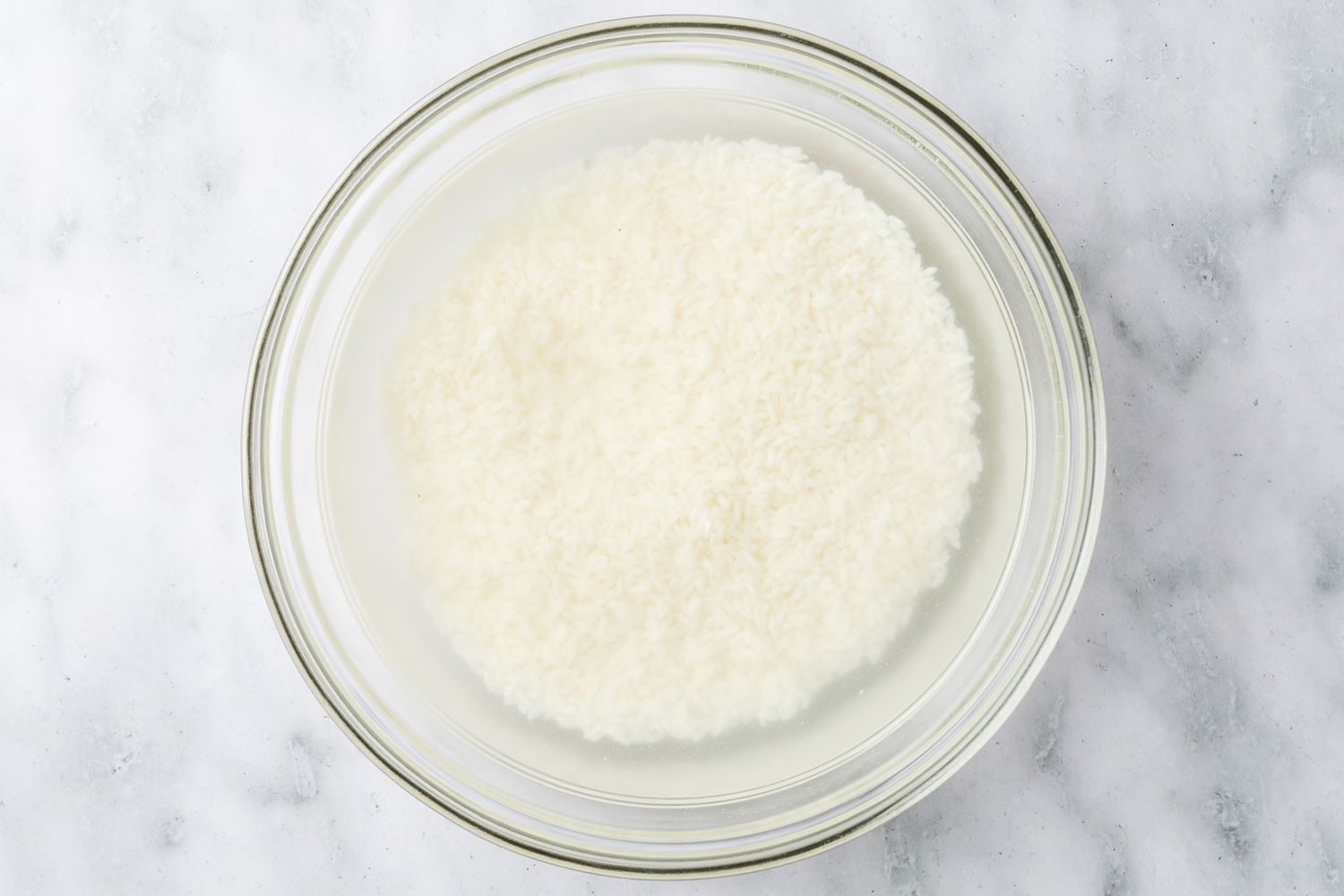 sweet rice soaking in a bowl for biko (Filipino sticky rice cake) recipe