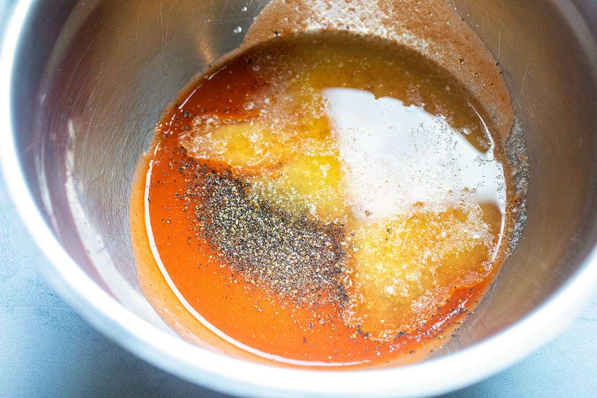 Ingredients to make Buffalo Cauliflower in a metal bowl.