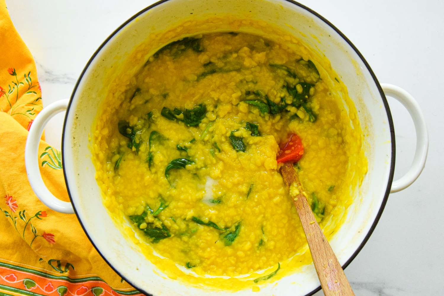Lime Juice Added to Daal Palak in a Dutch Oven on the Counter 