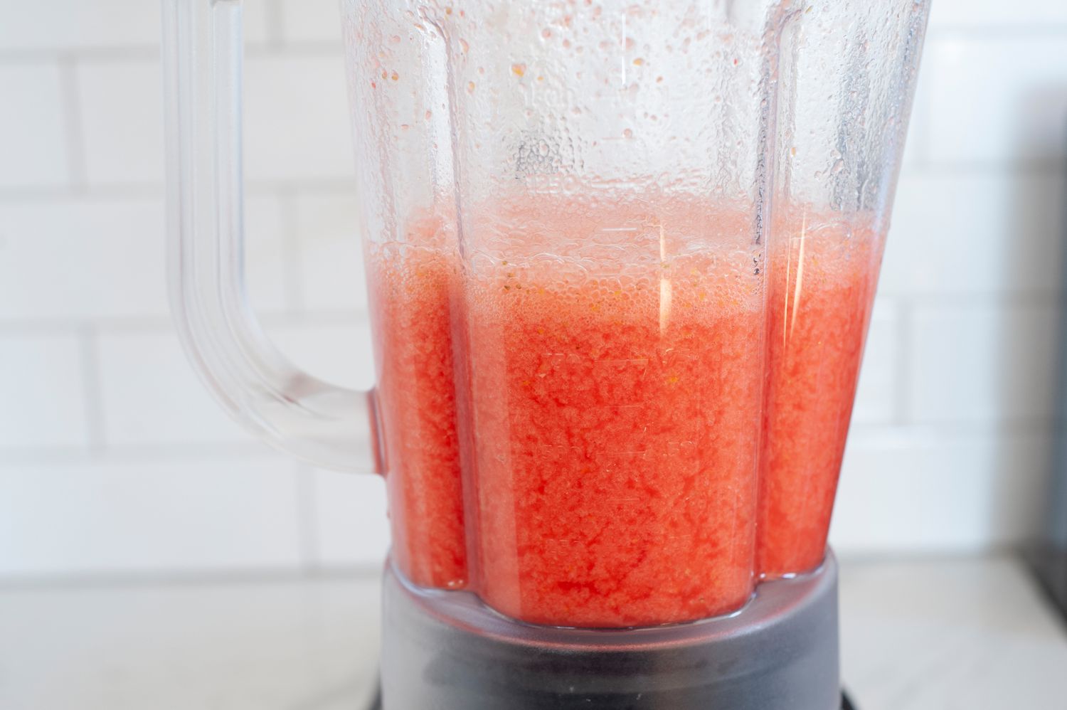 Blended homemade strawberry lemonade in a blender container.