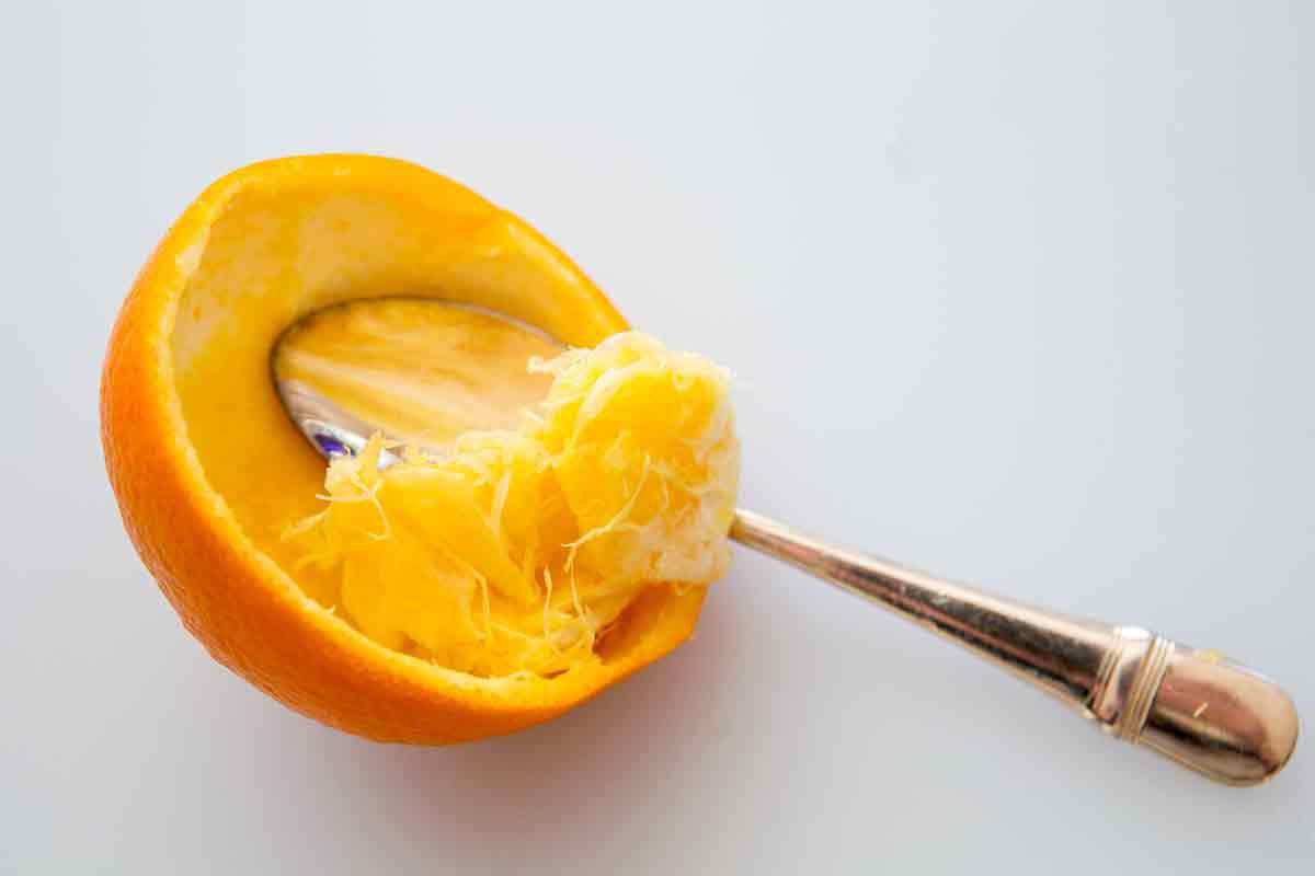 scrape orange with spoon