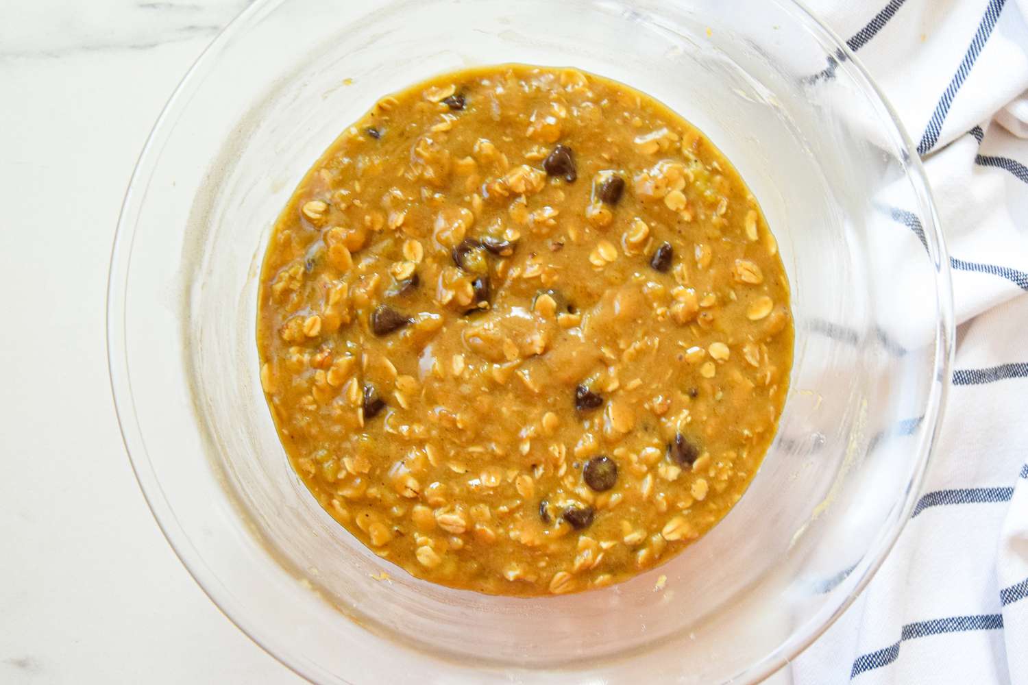 Oatmeal Banana Cookies Batter in a Bowl Next to a Kitchen Towel 