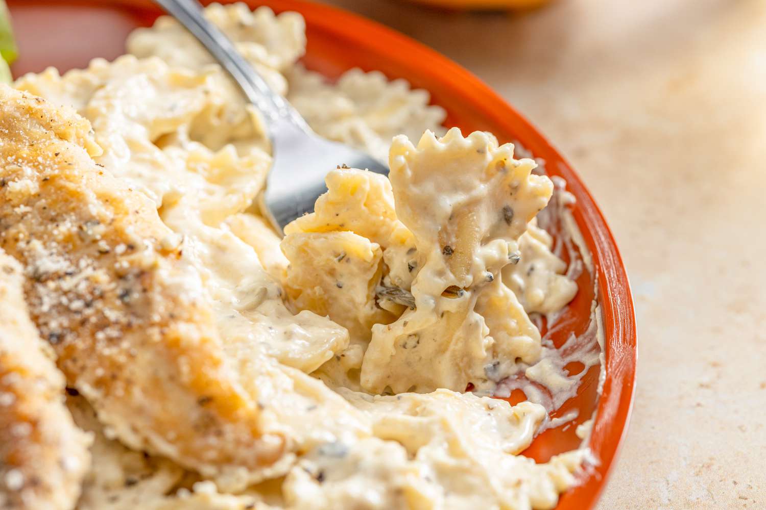 close-up: chicken caesar pasta on a fork