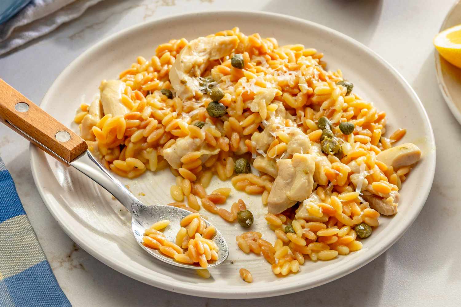 One-Pot Lemon Chicken Orzo on a plate with a spoon