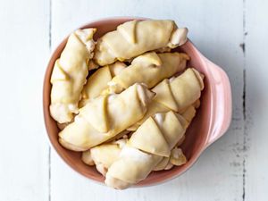 Overhead view of Butterhorn Cookies Filled with Walnut Meringue in a pink bowl.