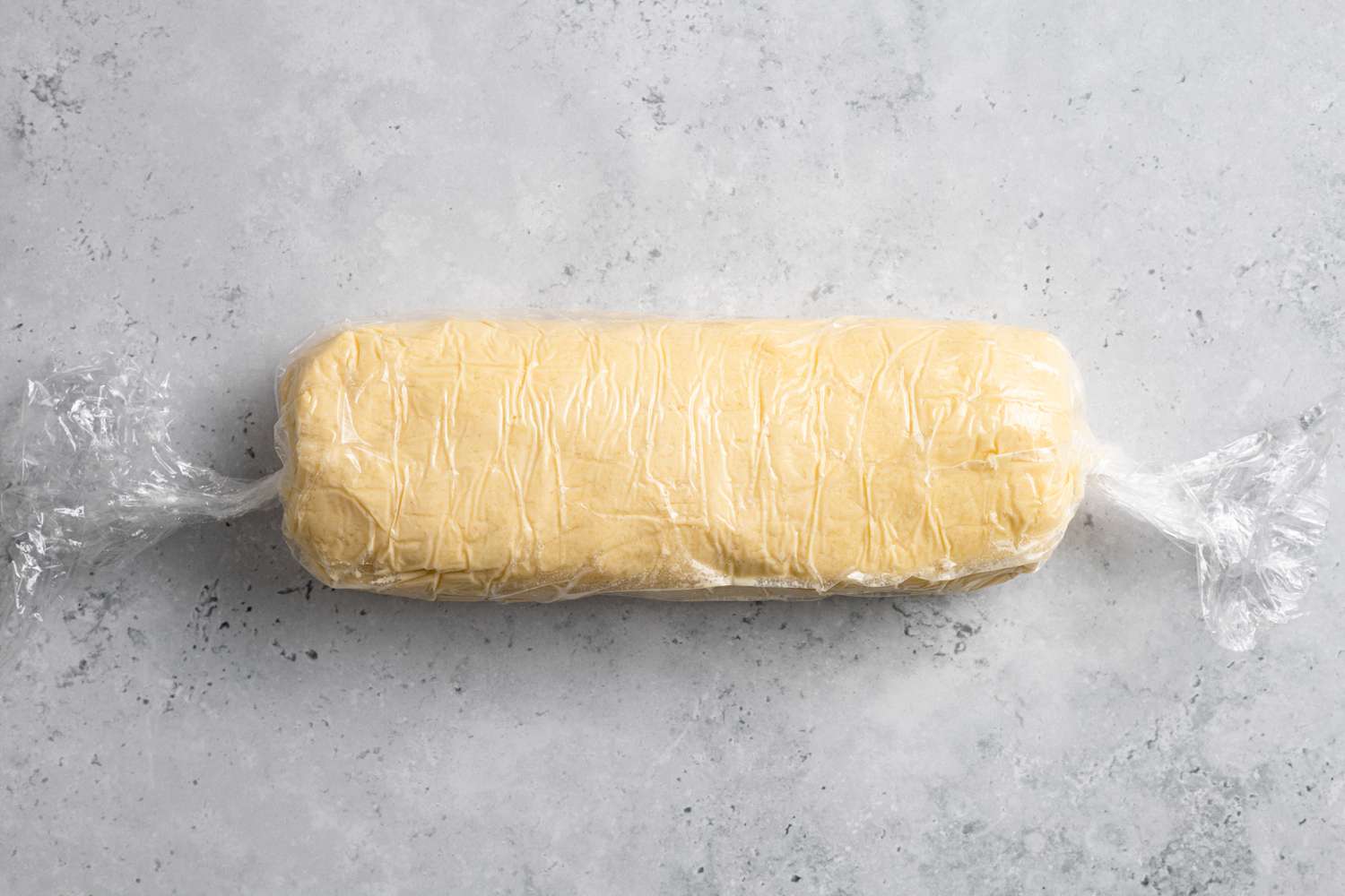 Roll of Classic Shortbread Cookie Dough Wrapped in Plastic Wrap for Slice-and-Bake Cookies