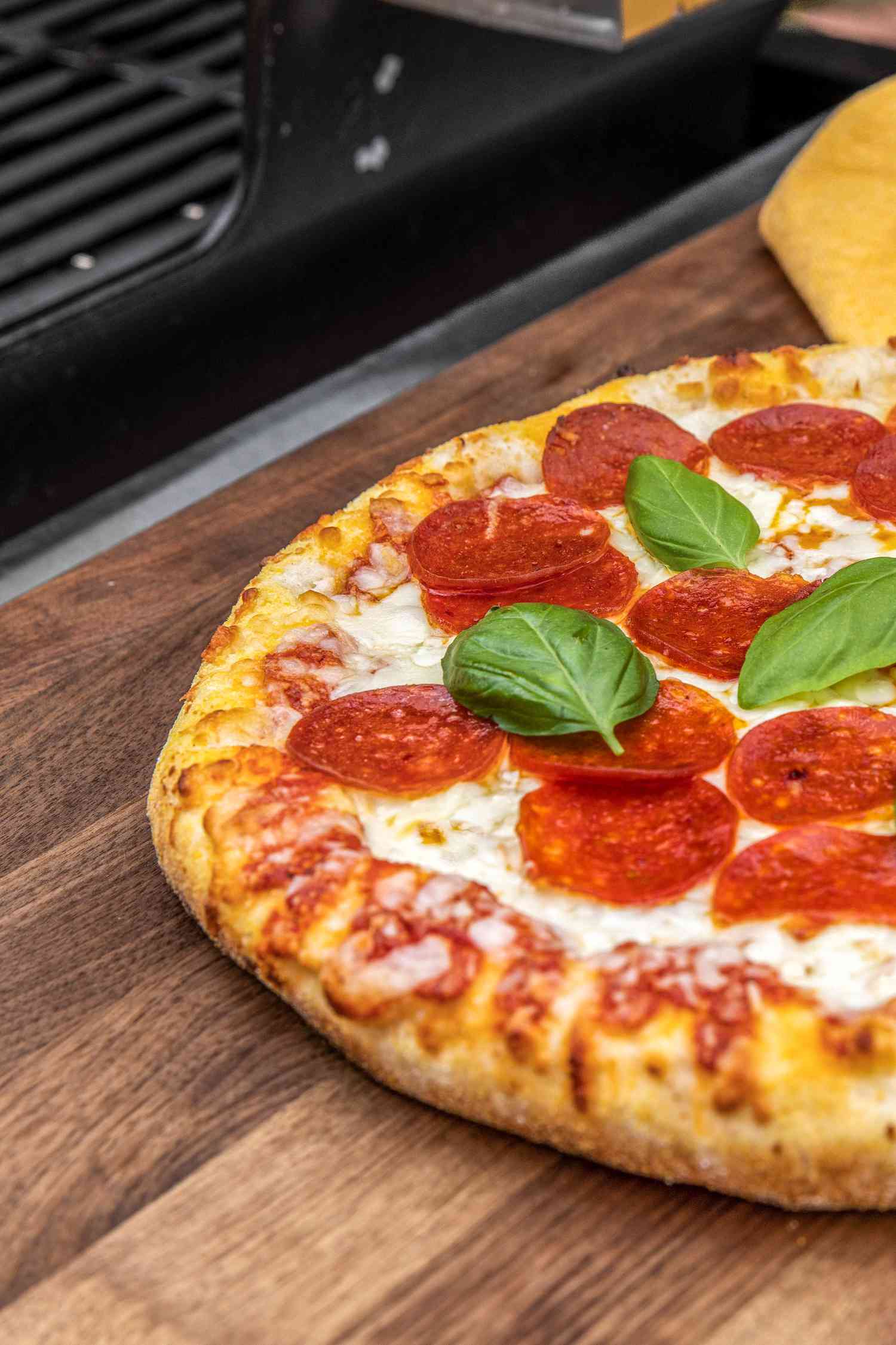Pepperoni pizza next to the grill