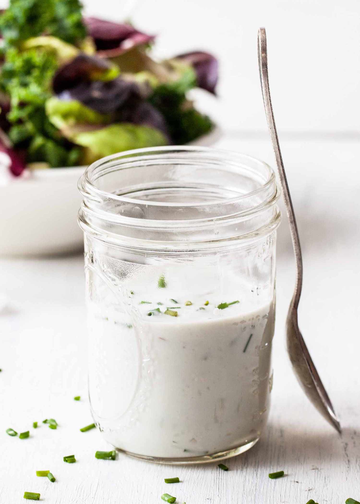 Blue Cheese Salad Dressing - - salad dressing with salad in background.