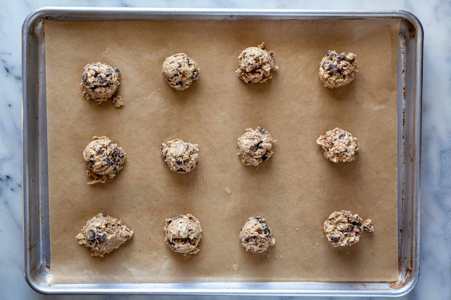 Scoops of dough on a sheet pan to bake for Laura Bush's Cowboy Cookies recipe