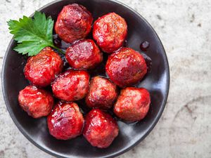 Cranberry Glazed Meatballs in a bowl garnished with parsley