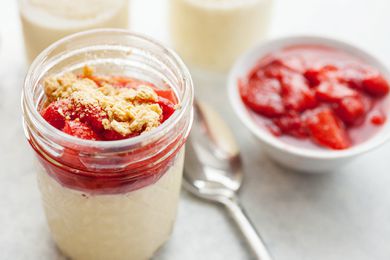 Sous vide cheesecake in a jar topped with strawberries