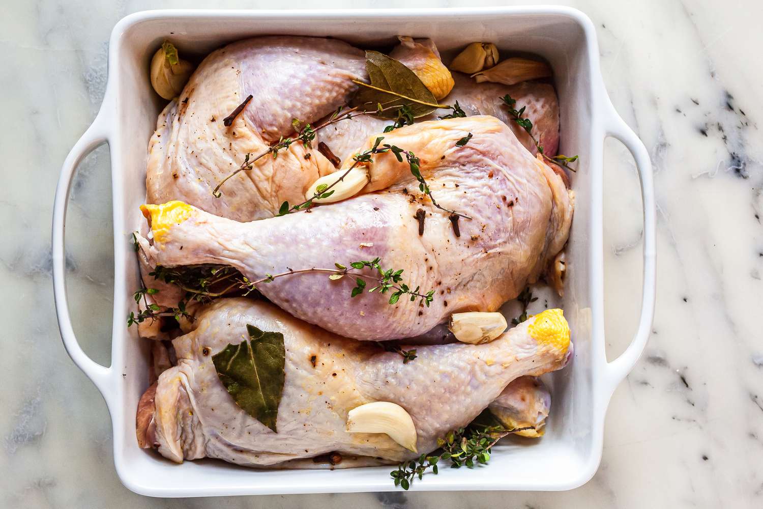 Salted chicken with garlic, thyme and bay leaves.